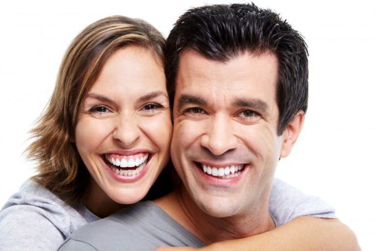 man and woman grinning wide white background