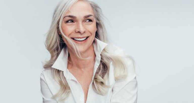 older woman with long hair smiling